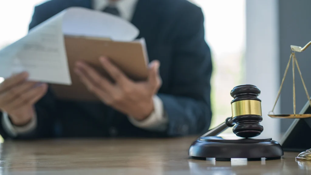 A lawyer holding a clip board while sitting in an office.