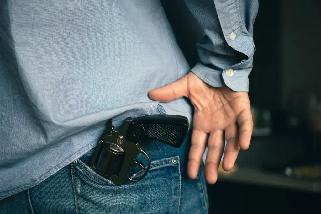 Man pulling a gun from his pocket.